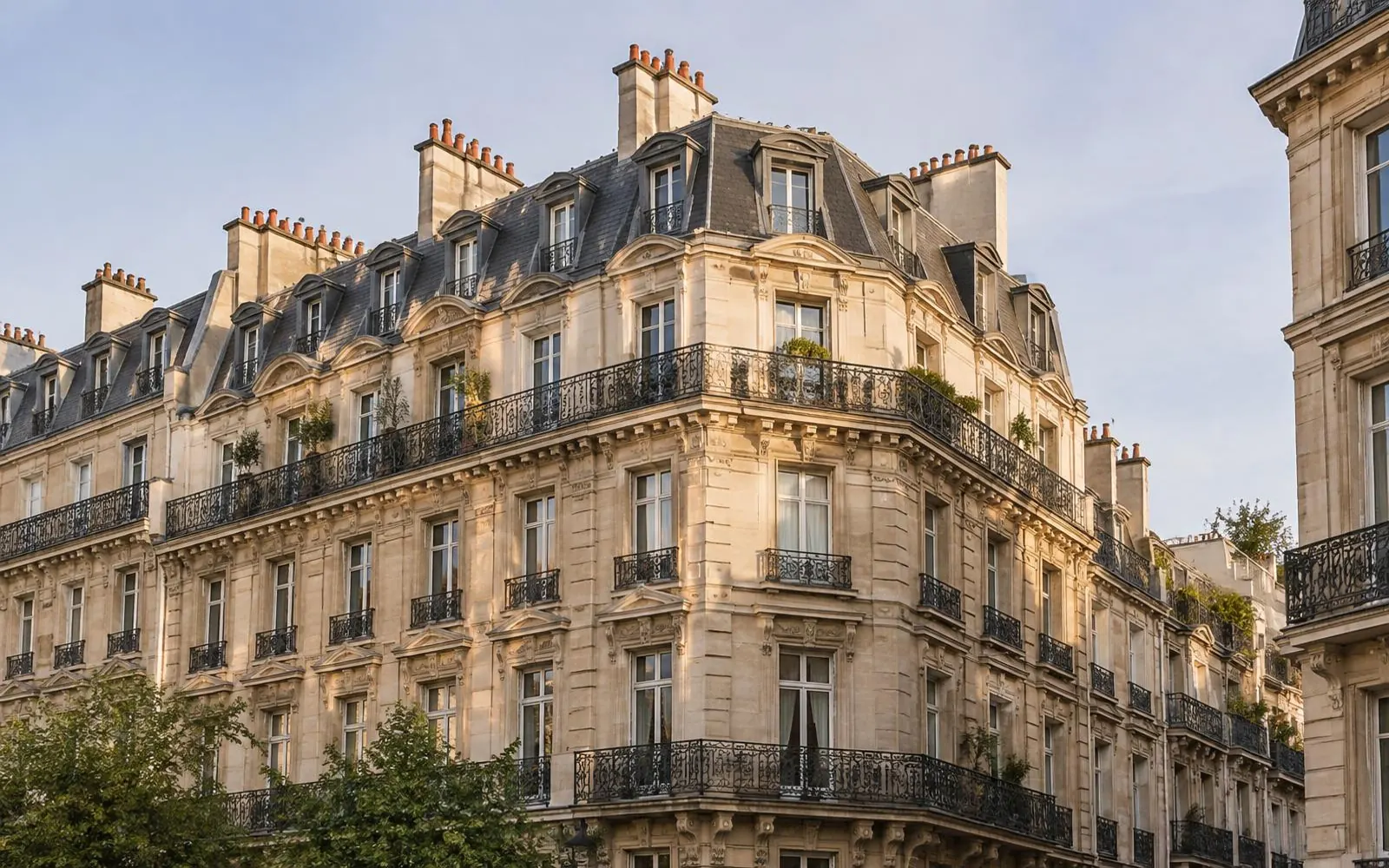Immeuble haussmannien en pierre, toiture en zinc et balcons — photo d’illustration
